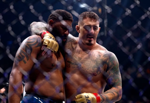 Tom Aspinall (right) consoles Curtis Blaydes after knocking out the American. PHOTO: REUTERS